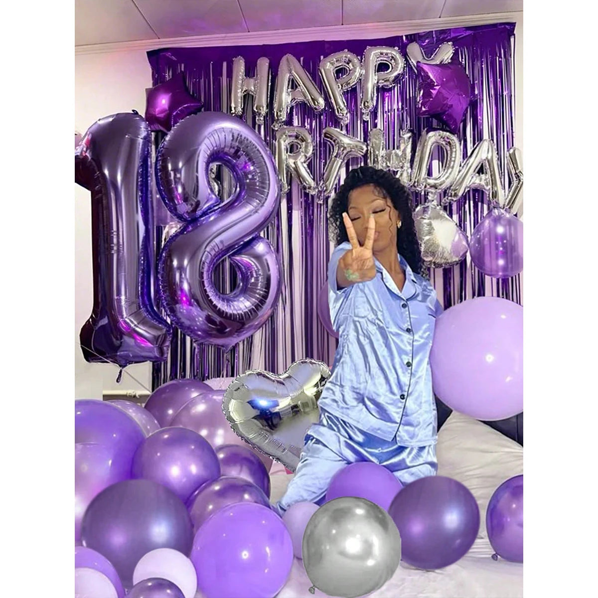 A purple and black birthday balloon set featuring metallic and heart-shaped accents against a purple backdrop.