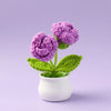 Hand woven crochet purple rose plant in a white pot