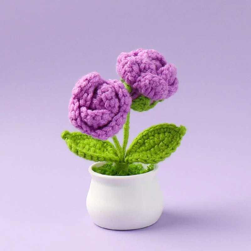 Hand woven crochet purple rose plant in a white pot