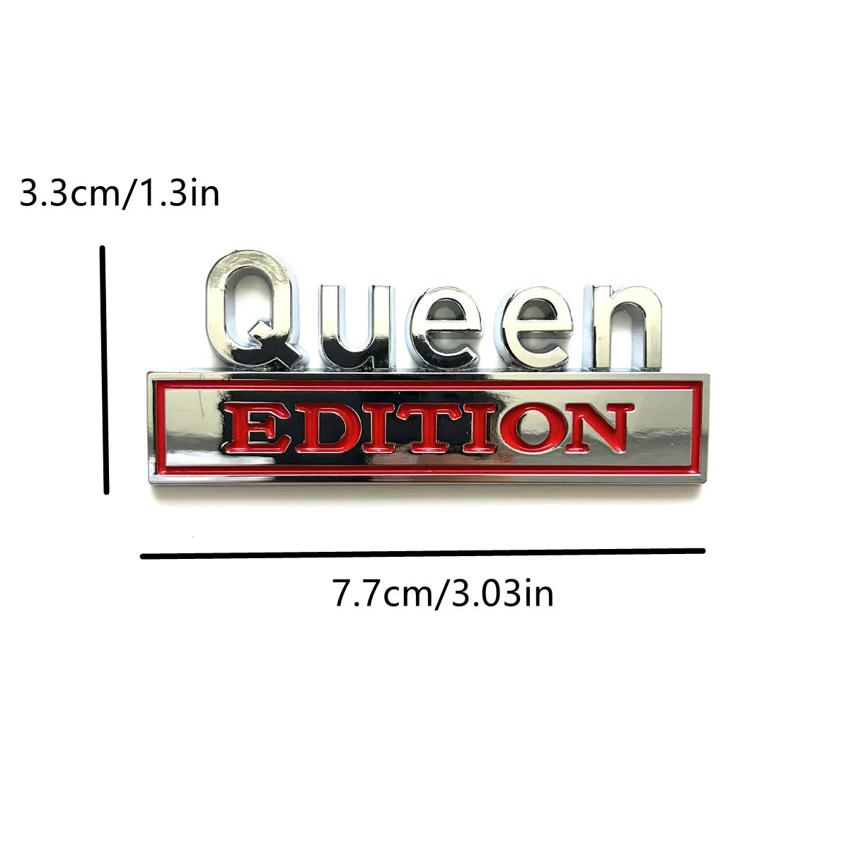 Silberes Emblem mit dem Text Queen Edition in einer rechteckigen Platte eingraviert.