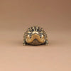 Antique brass crocodile figurine with detailed texture and expression, used as vintage desk decor.