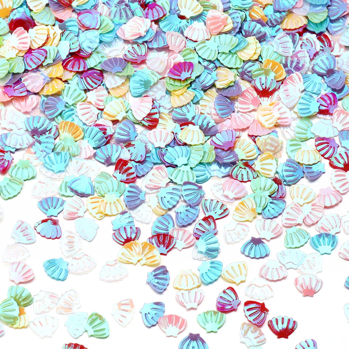 A pile of iridescent sea shell PVC sequins in various pastel colors like pink, blue, and yellow for nail art and craft decora
