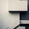 Abstract minimalist architecture featuring white horizontal lines and dark gray surfaces.
