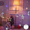 String lights featuring star and moon shapes hanging in front of a lamp and Christmas tree decor