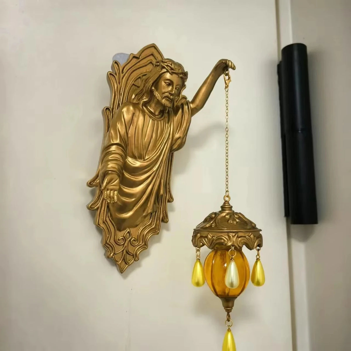 A vintage bronze resin sculpture of a mermaid with flowing hair and a hanging glass lamp.