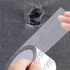 A hand is applying a self-adhesive window screen repair patch to a mesh screen, demonstrating a quick fix for holes or tears.