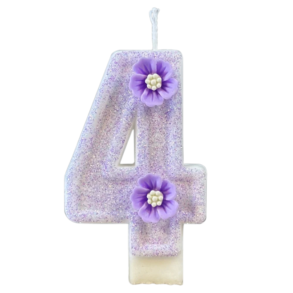 A sparkling purple number four candle decorated with a purple flower on a white base.