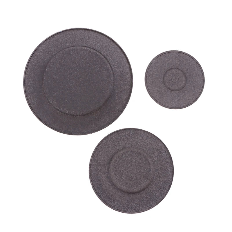 A set of three round, dark gray gas stove burner caps.