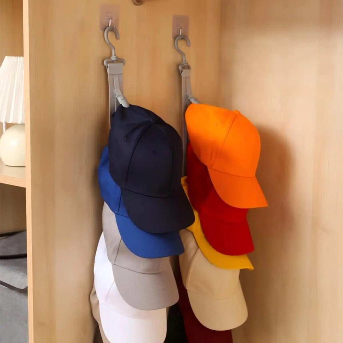 A rack displaying various colored hats hanging on a wooden closet rod.