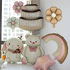 A collection of light pink and beige foil balloons, including a bear, flowers, and a birthday banner.