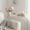 Elegant pink acrylic butterfly plaque displayed on a white shelf next to a candle and flowers.