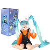 A PVC collectible figurine of Hatsune Miku in an orange outfit with black overalls and light blue hair, sitting on a purple b
