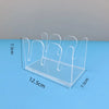Clear acrylic cap storage rack with multiple display slots shown on a blue surface.