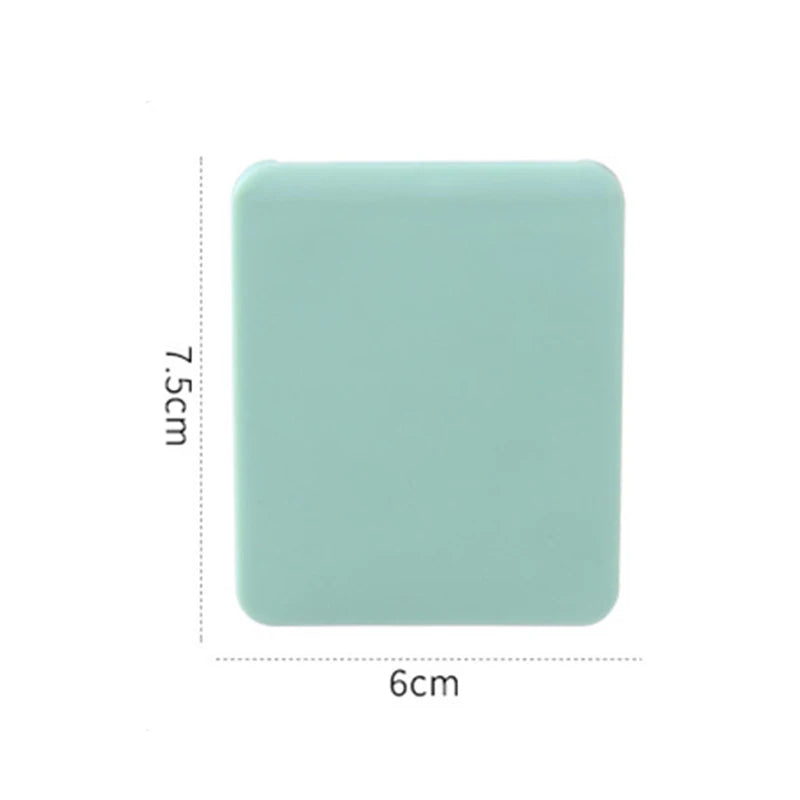A square, light mint green compact foldable travel makeup mirror with dimensions 7.5cm by 6cm.