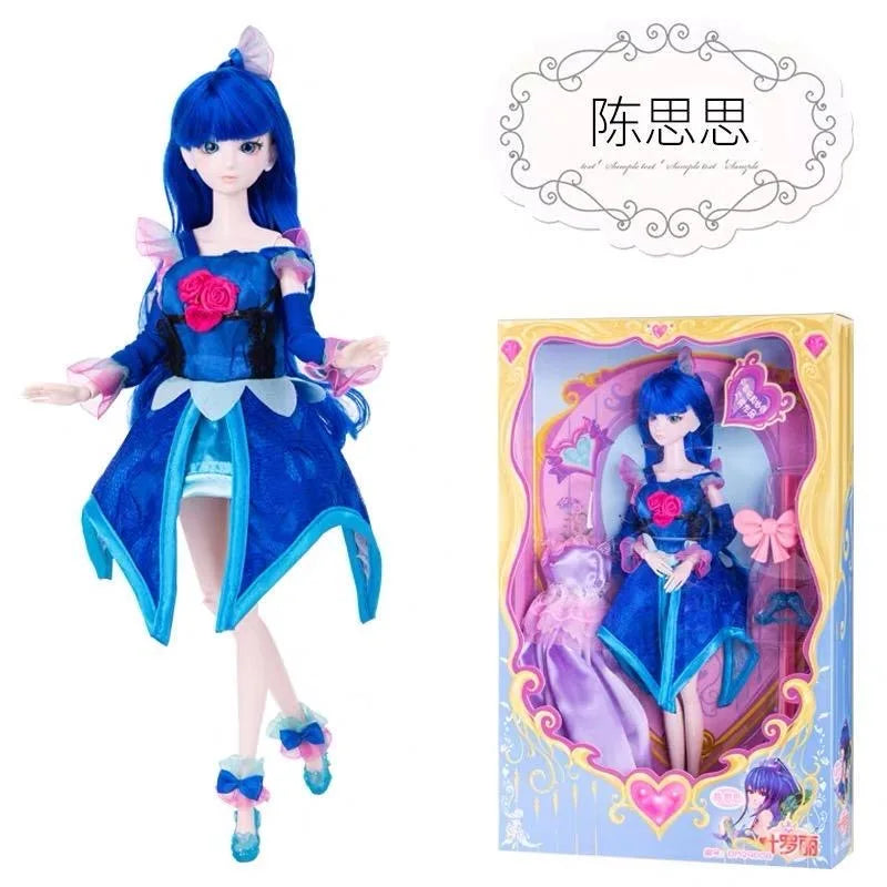 A blue ball-jointed doll with detailed makeup and an elaborate blue outfit displayed in its packaging.