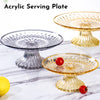 Clear acrylic serving plates displayed on a marble surface with fresh fruit.