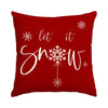 A deep red cushion cover featuring white text 'let it snow' and a central snowflake design.