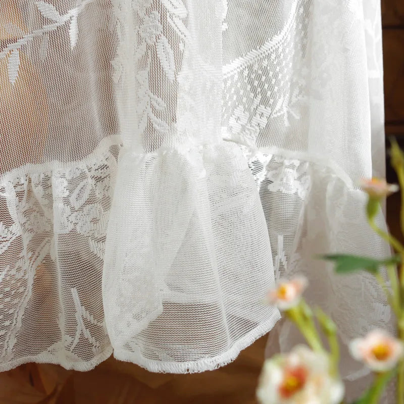 Elegant white floral lace tablecloth with sheer fabric and delicate embroidery
