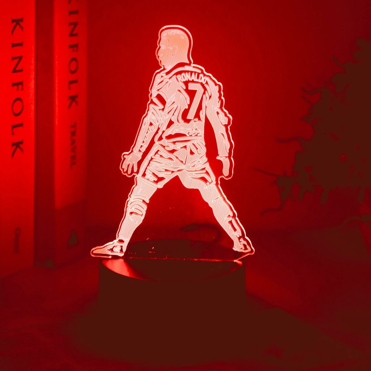 A glowing 3D silhouette of a football player wearing number 7 stands on a dark surface against a red background.