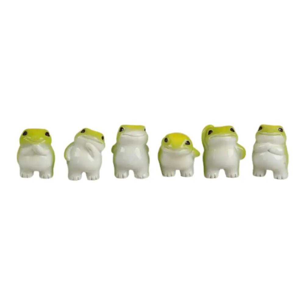 A set of six cute mini resin frog figurines in white and yellow for desk and garden decor.