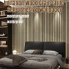 A close-up of imitation wood grain self-adhesive wallpaper covering a wall behind a modern bed.