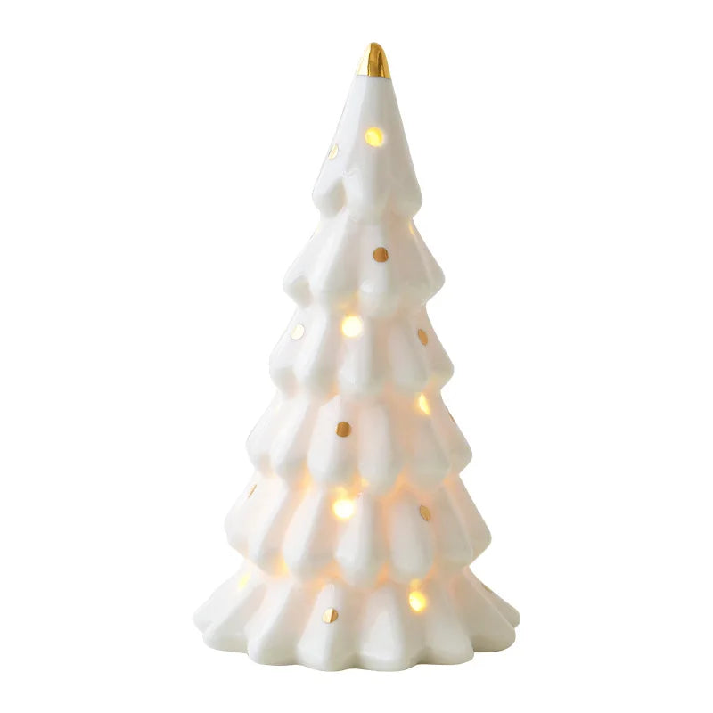 A white ceramic glow-in-the-dark mini Christmas tree decor with warm lights.