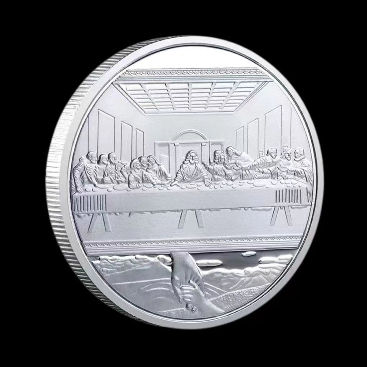 A silver commemorative coin depicting a scene from the Last Supper with figures seated at a table.