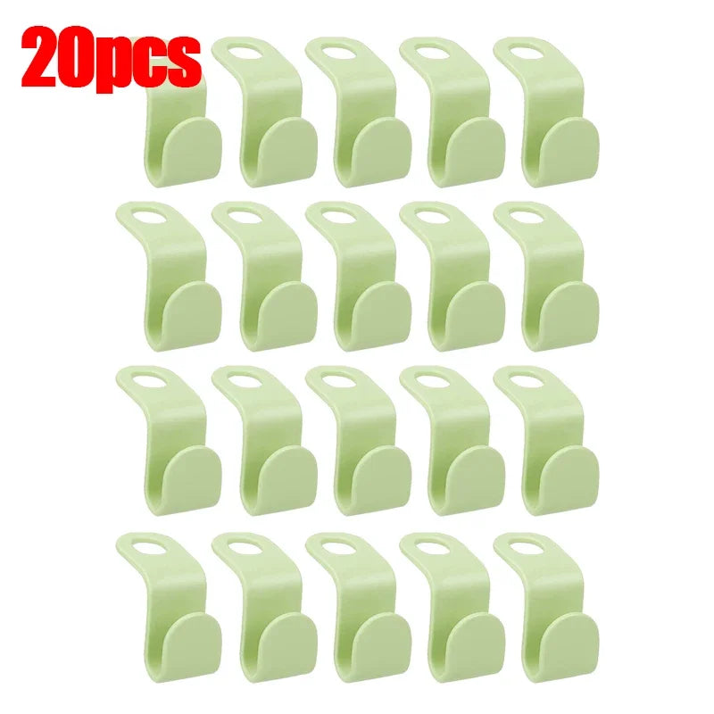 A set of 30 light green space-saving hanger connector hooks for organizing items.