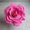 A vibrant pink silk foam rose with layered petals and green stem, used for home and event decoration.