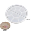 A white silicone mold with multiple depressions for crafting gypsum, concrete, and resin.