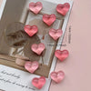 A set of ten pink heart-shaped resin refrigerator magnets displayed on a light background.