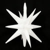 A white star burst foil balloon with sharp points, suspended against a black background.