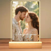 A personalized acrylic photo frame displaying a close-up portrait of a couple with the text I love you engraved.