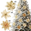 A set of six glittered artificial gold and cream flowers with clips displayed next to a decorated Christmas tree.