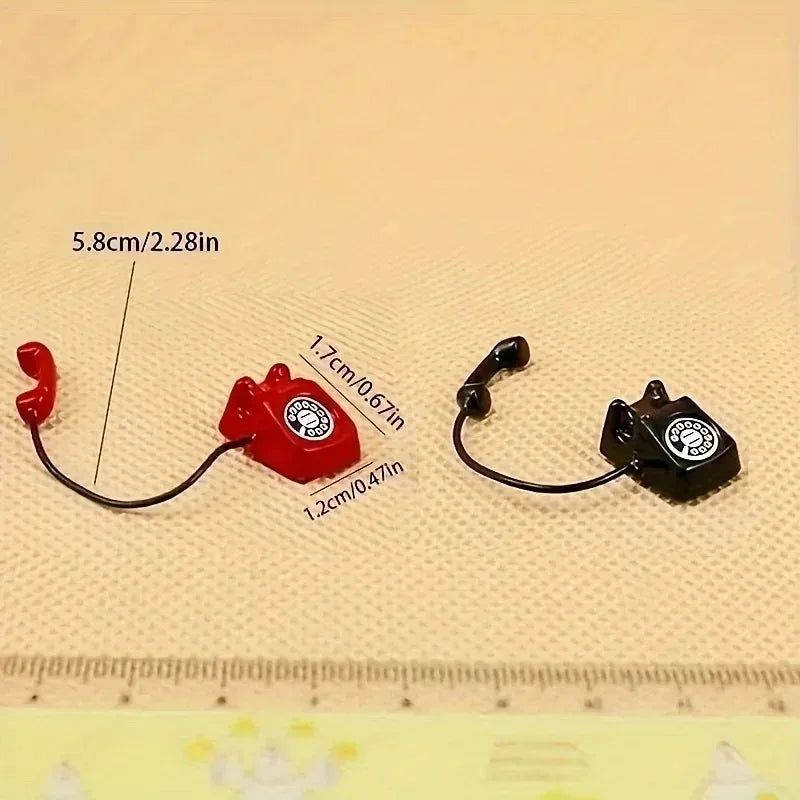A red and black retro rotary desk phone miniature for dollhouse decor shown next to a ruler.