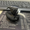 A black 3D printed Grim Reaper duck statue with a white wing, resting on a dark surface.