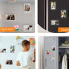 A set of acrylic magnetic fridge frames for mini photos displayed on a wall and mounted on a steel refrigerator door.