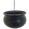 A black witch cauldron candy bowl hanging by a thin cord.