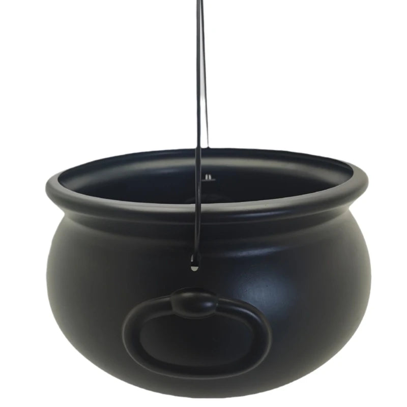 A black witch cauldron candy bowl hanging by a thin cord.