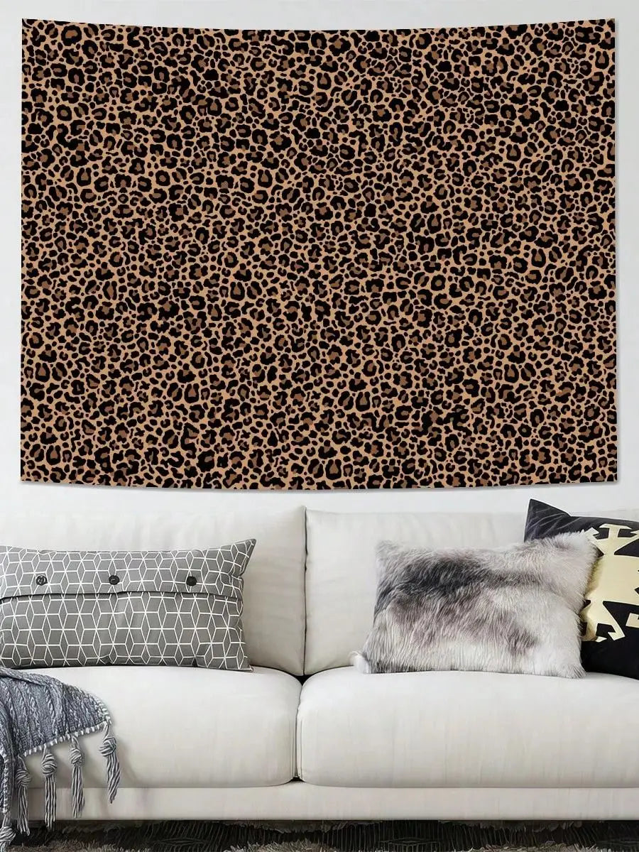 A wall hanging featuring a brown and black leopard print tapestry above a white sofa with gray and black pillows.