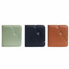 Three leather photo albums in sage green, navy blue, and tan brown.