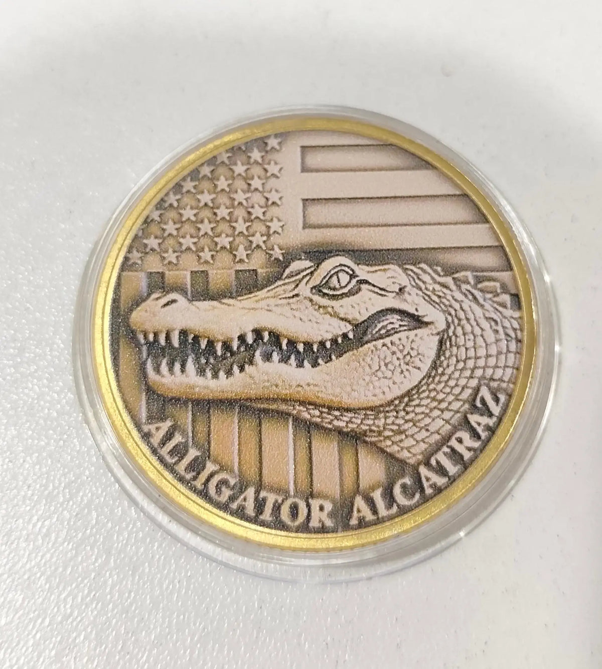 A round collectible coin featuring an alligator head against a background of American flag stripes and stars.