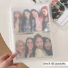 A clear photo album with 80 pockets displaying several photos of female idols.
