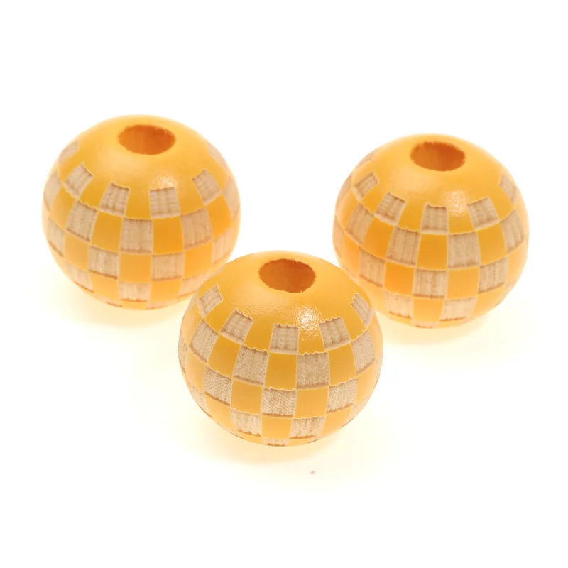 Three natural wooden checkered beads for jewelry making, round and yellow-toned.