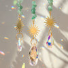 Handcrafted moon crystal suncatcher featuring a gold pendant with a faceted prism gemstone.