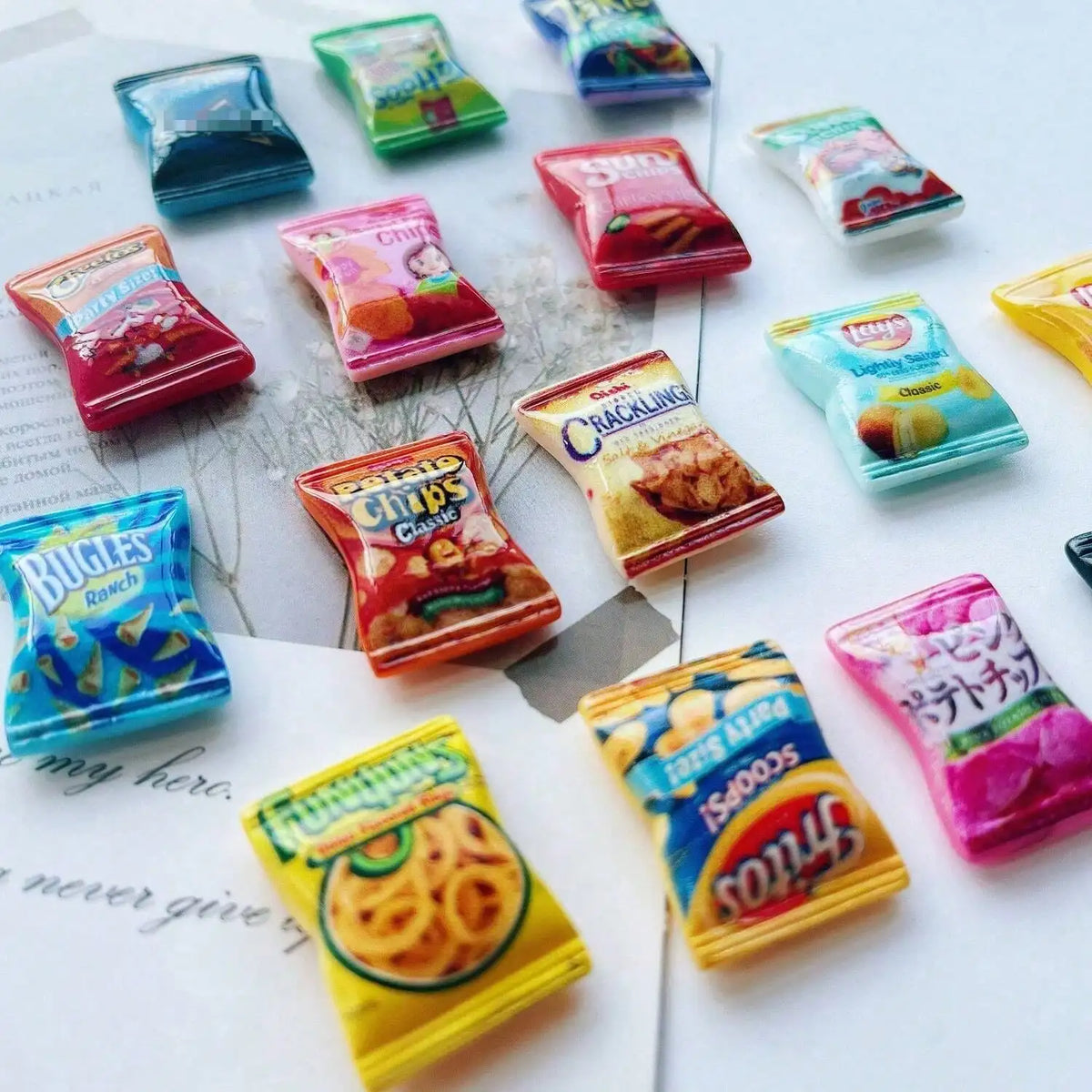 A collection of colorful candy-shaped refrigerator magnets, including gummies and jellies, arranged on a white surface.