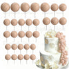A set of round, light pink foam cake toppers on sticks with gold accents.