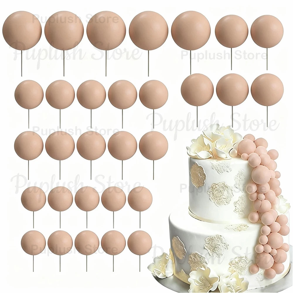 A set of round, light pink foam cake toppers on sticks with gold accents.