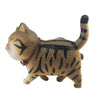 A small, brown 3D cartoon cat figurine with black stripes, used as a refrigerator magnet.
