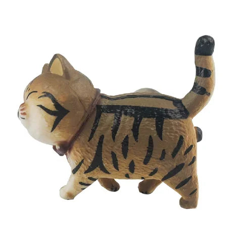 A small, brown 3D cartoon cat figurine with black stripes, used as a refrigerator magnet.